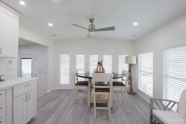 a view of a dining room with furniture and wooden floor