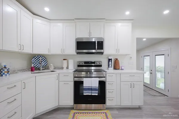 a kitchen with a stove top oven and cabinets