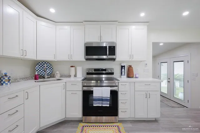 a kitchen with a stove top oven and cabinets