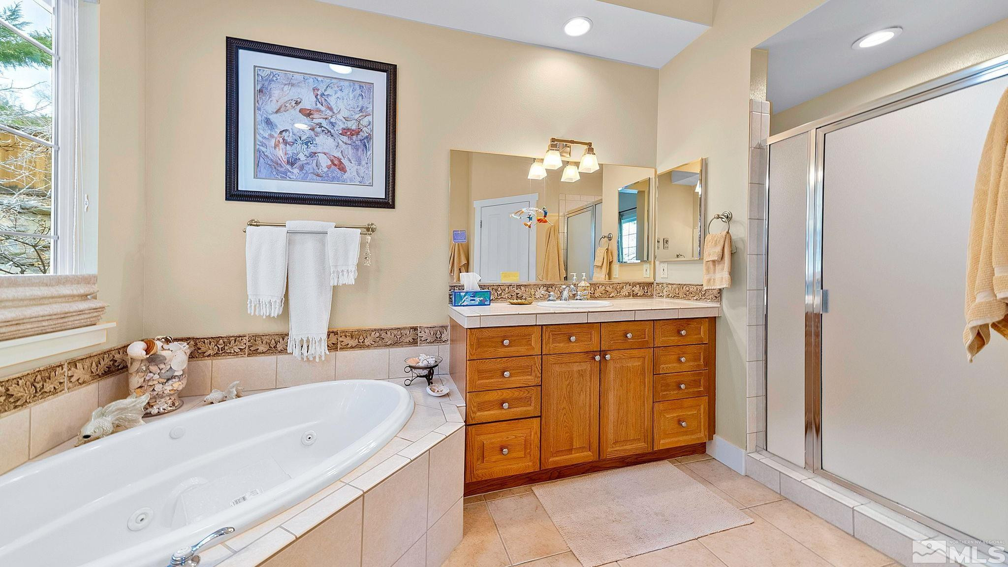 4940 Turning Leaf Way Reno, NV 89519 - Photo 22 of 34 a spacious bathroom with a double vanity sink mirror and double