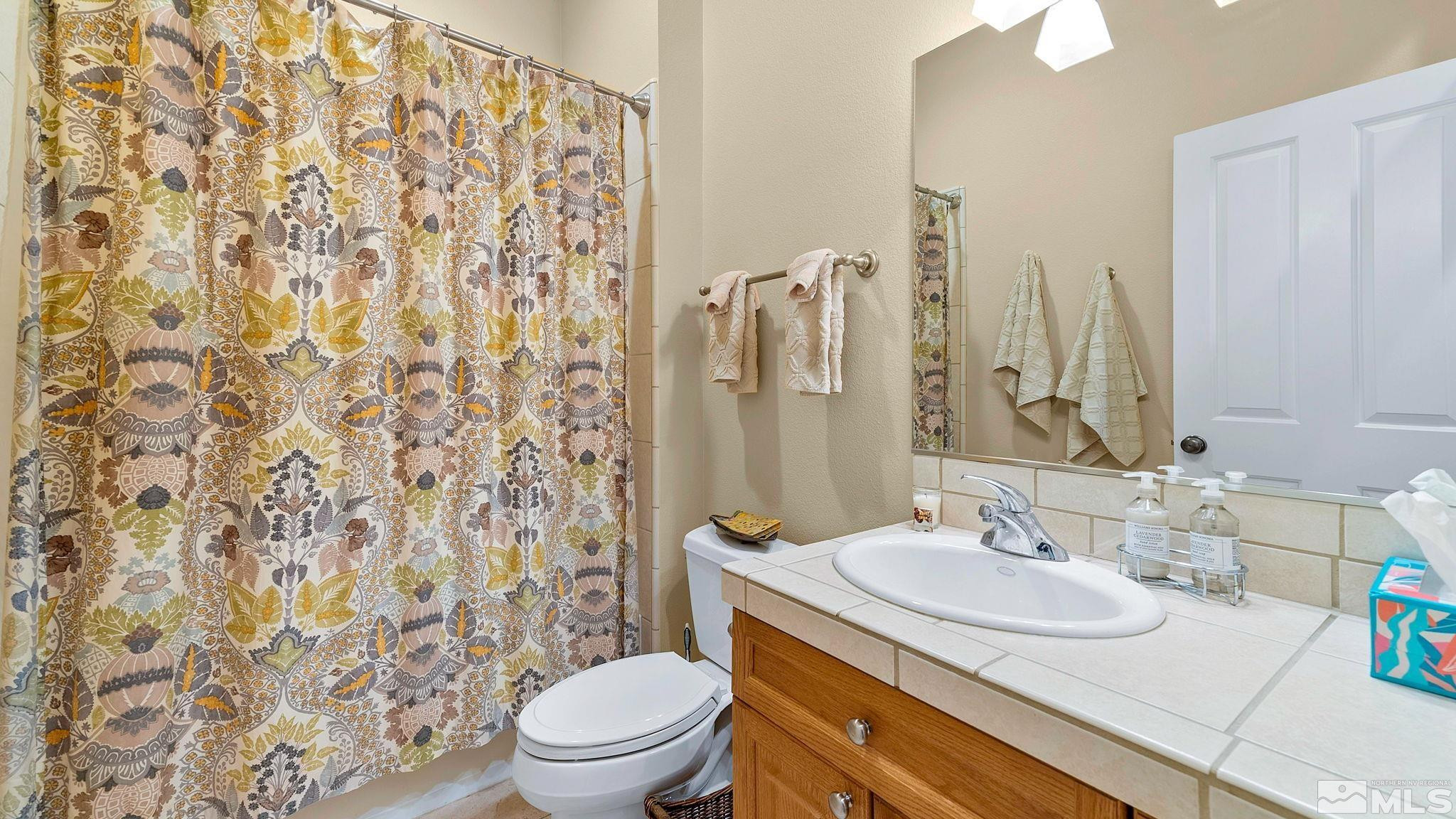 4940 Turning Leaf Way Reno, NV 89519 - Photo 25 of 34 a bathroom with a sink toilet and shower