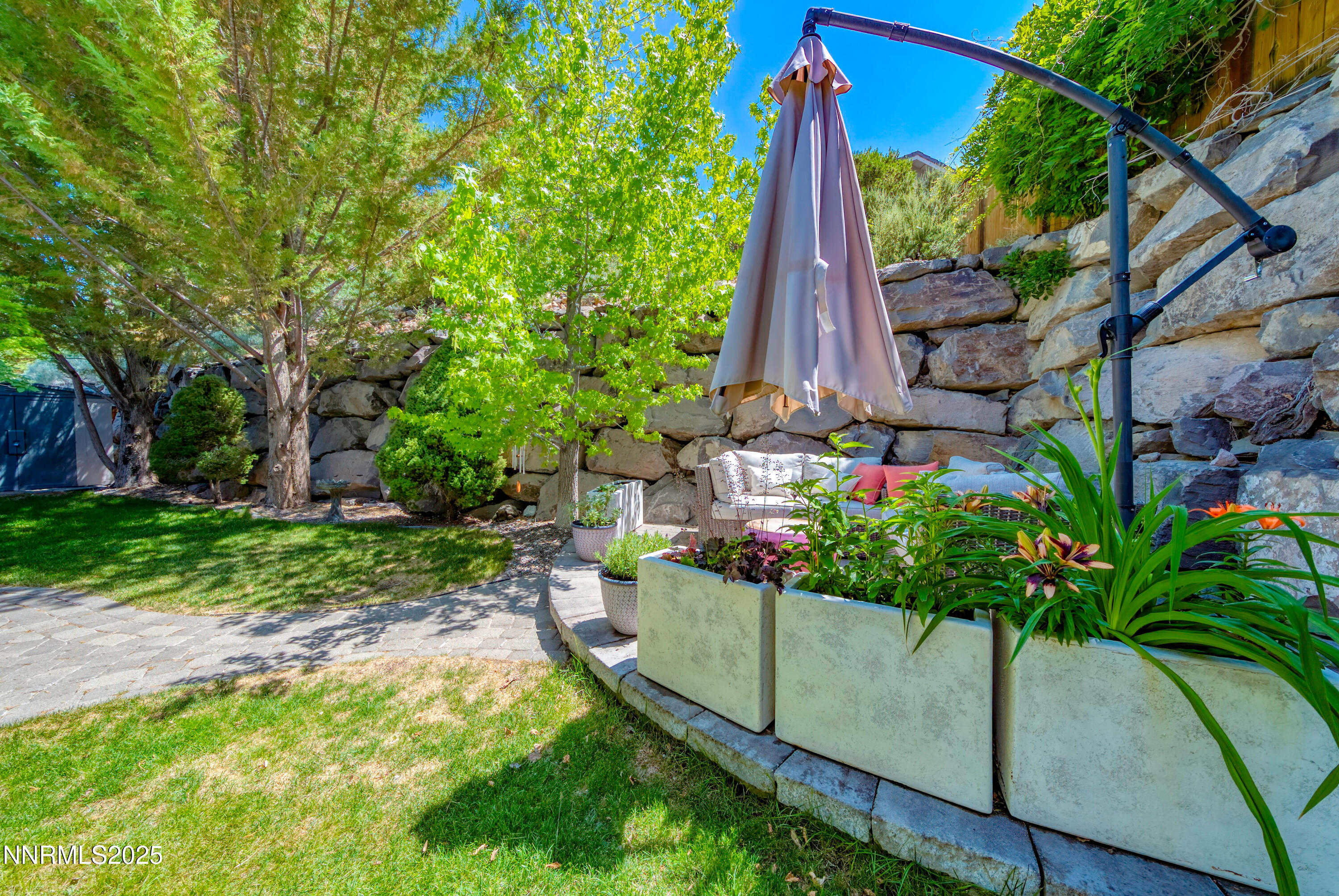 4940 Turning Leaf Way Reno, NV 89519 - Photo 28 of 34 a view of a backyard with potted plants and large tree