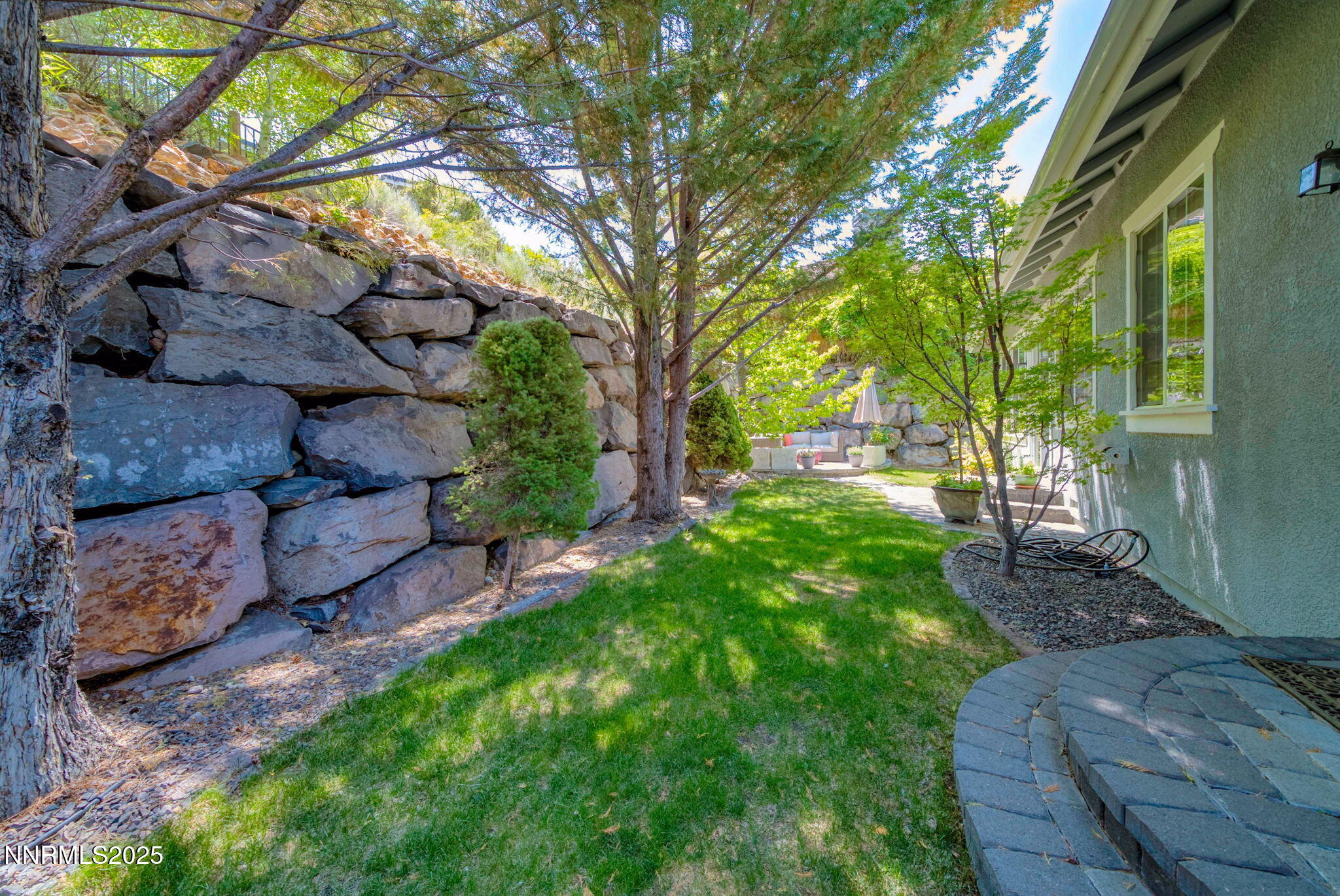 4940 Turning Leaf Way Reno, NV 89519 - Photo 31 of 34 a view of a yard with plants and a large tree