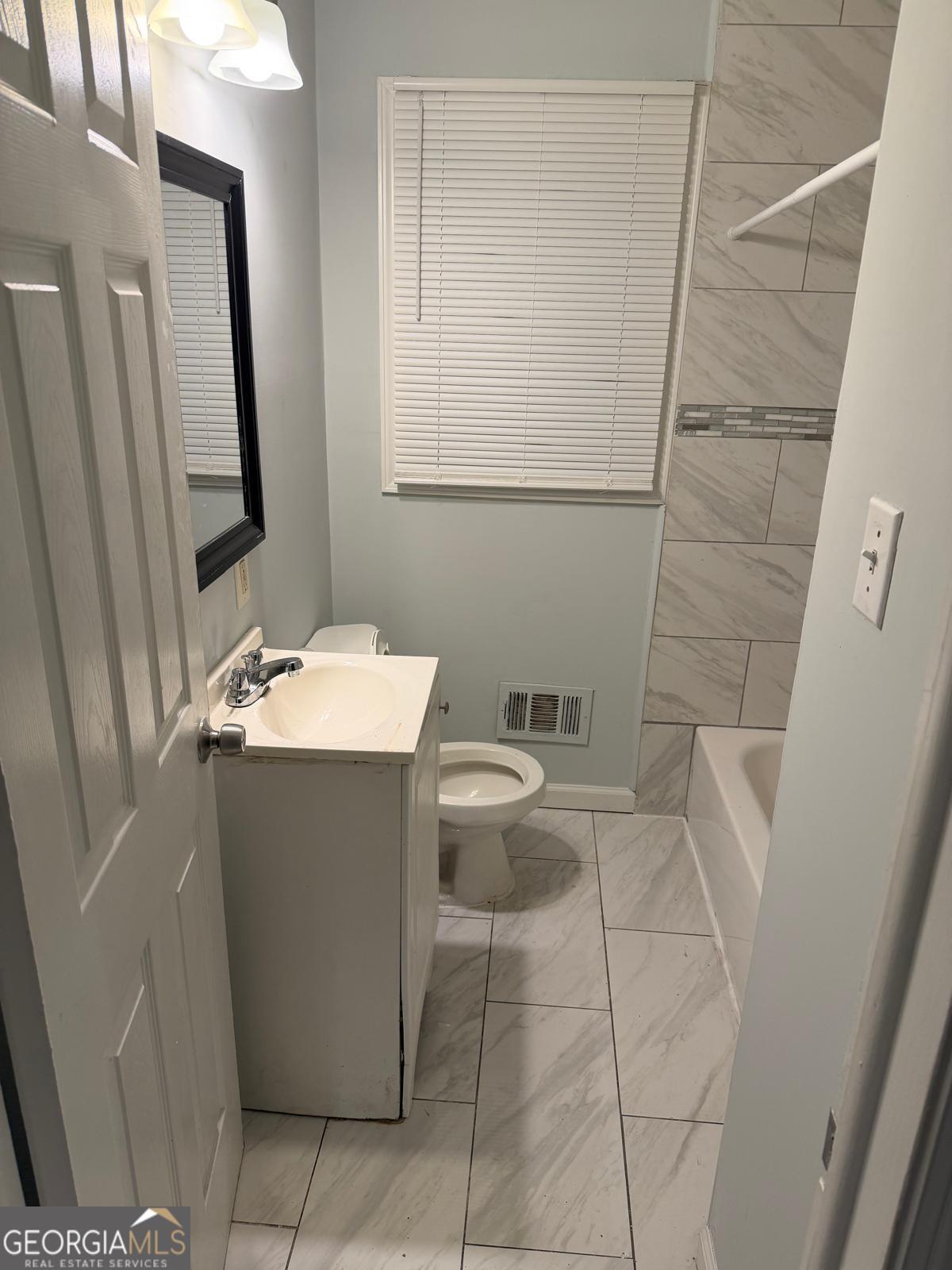 3456 Thompson Drive Northwest Atlanta, GA 30331 - Photo 12 of 18 a bathroom with a sink toilet and mirror