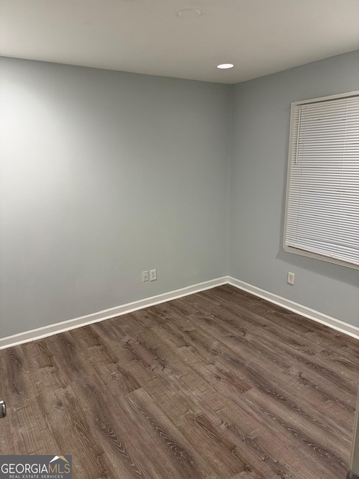 3456 Thompson Drive Northwest Atlanta, GA 30331 - Photo 14 of 18 a view of an empty room with wooden floor and a window