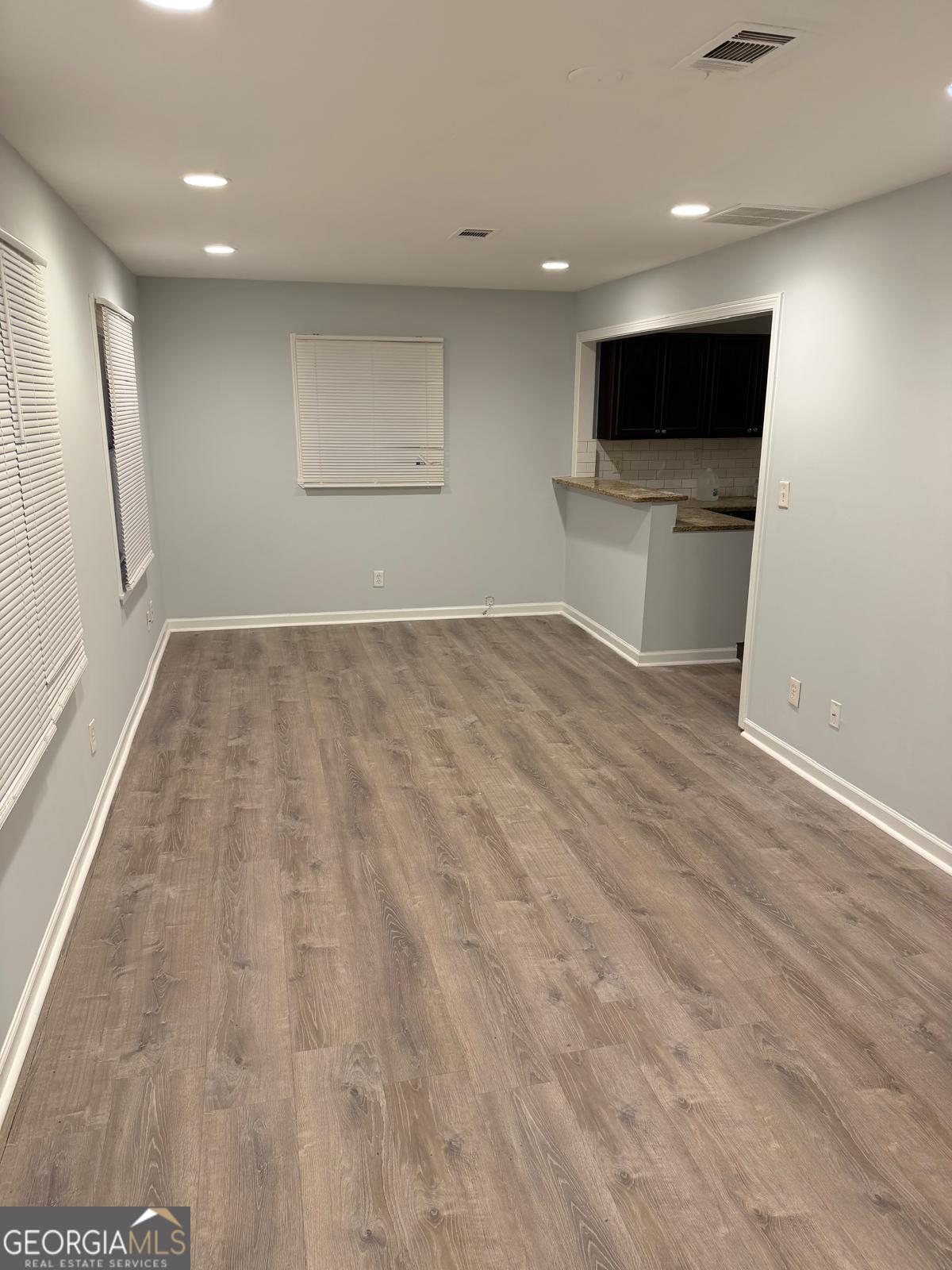 3456 Thompson Drive Northwest Atlanta, GA 30331 - Photo 15 of 18 an empty room with wooden floor and stainless steel appliances
