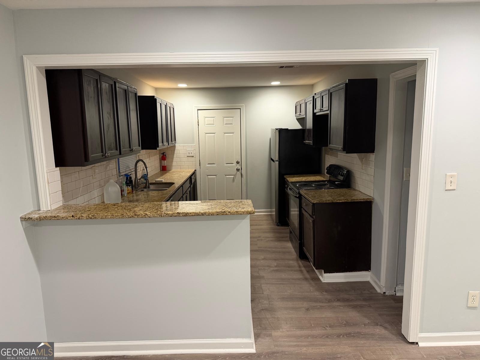 3456 Thompson Drive Northwest Atlanta, GA 30331 - Photo 2 of 18 a kitchen with stainless steel appliances granite countertop a refrigerator and a sink