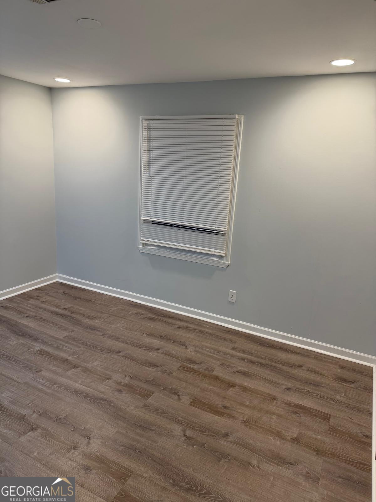 3456 Thompson Drive Northwest Atlanta, GA 30331 - Photo 7 of 18 an empty room with wooden floor and windows