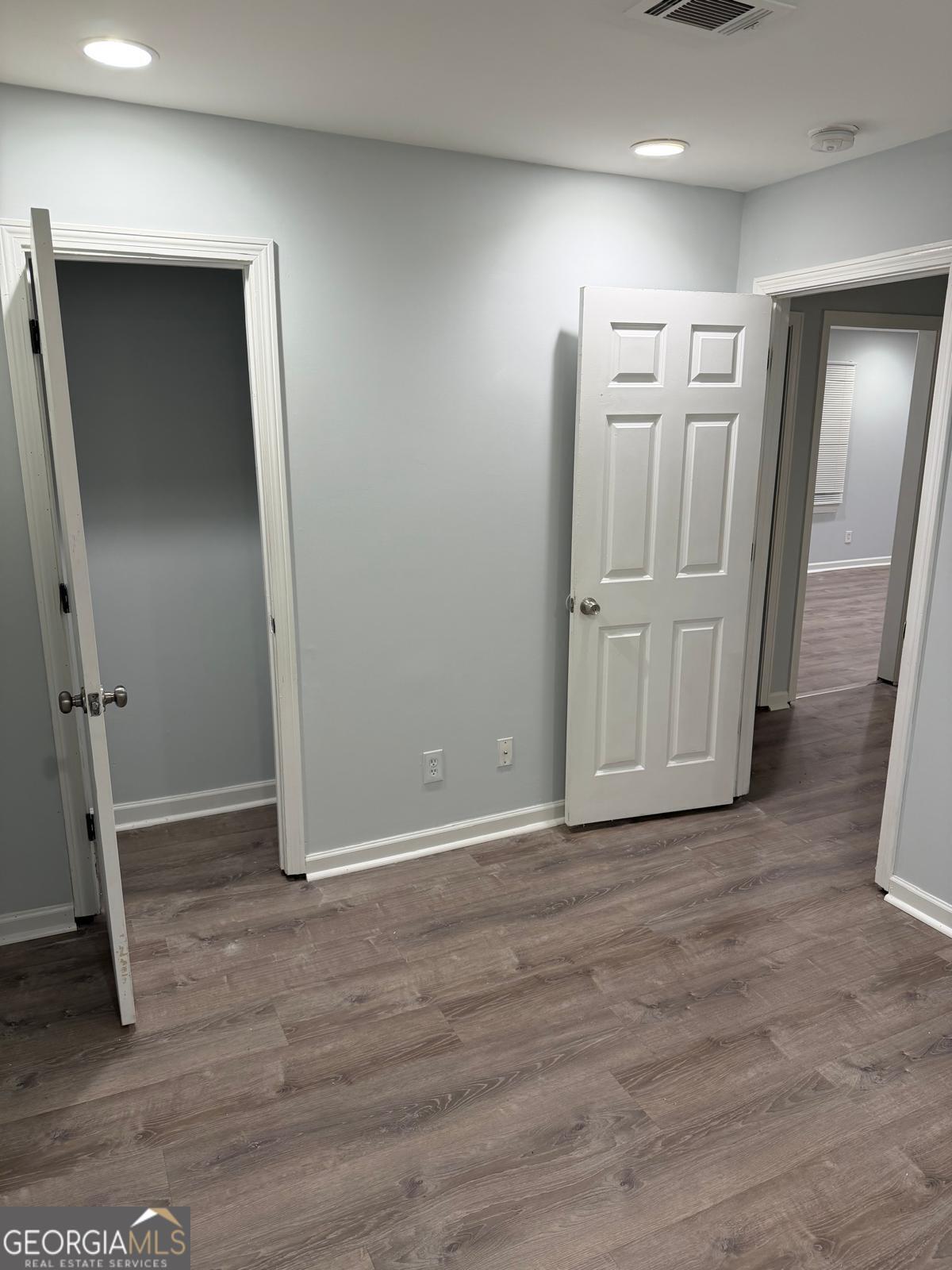 3456 Thompson Drive Northwest Atlanta, GA 30331 - Photo 8 of 18 an empty room with wooden floor and closet area