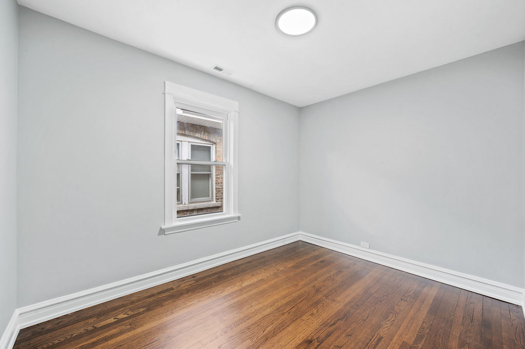 5230 West Deming Place Chicago, IL 60639 - Photo 13 of 45 a view of an empty room with wooden floor and a window