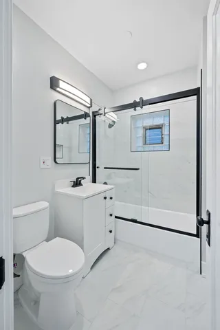 a bathroom with a toilet sink and shower