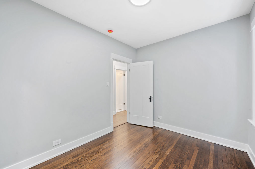 5230 West Deming Place Chicago, IL 60639 - Photo 19 of 45 a view of an empty room with wooden floor