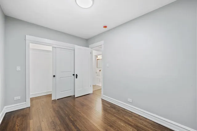 a view of an empty room and wooden floor