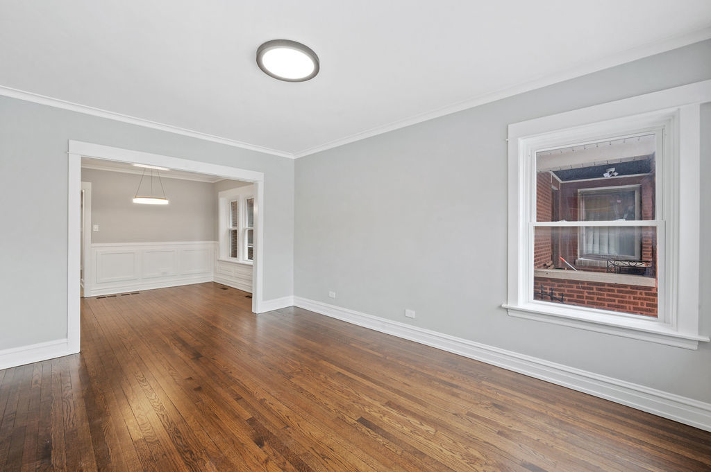 5230 West Deming Place Chicago, IL 60639 - Photo 35 of 45 a view of an empty room with wooden floor and a window