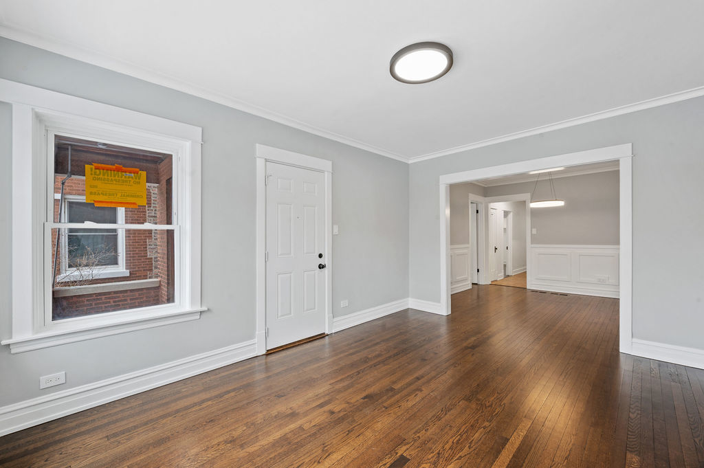 5230 West Deming Place Chicago, IL 60639 - Photo 36 of 45 a view of an empty room with wooden floor and a window