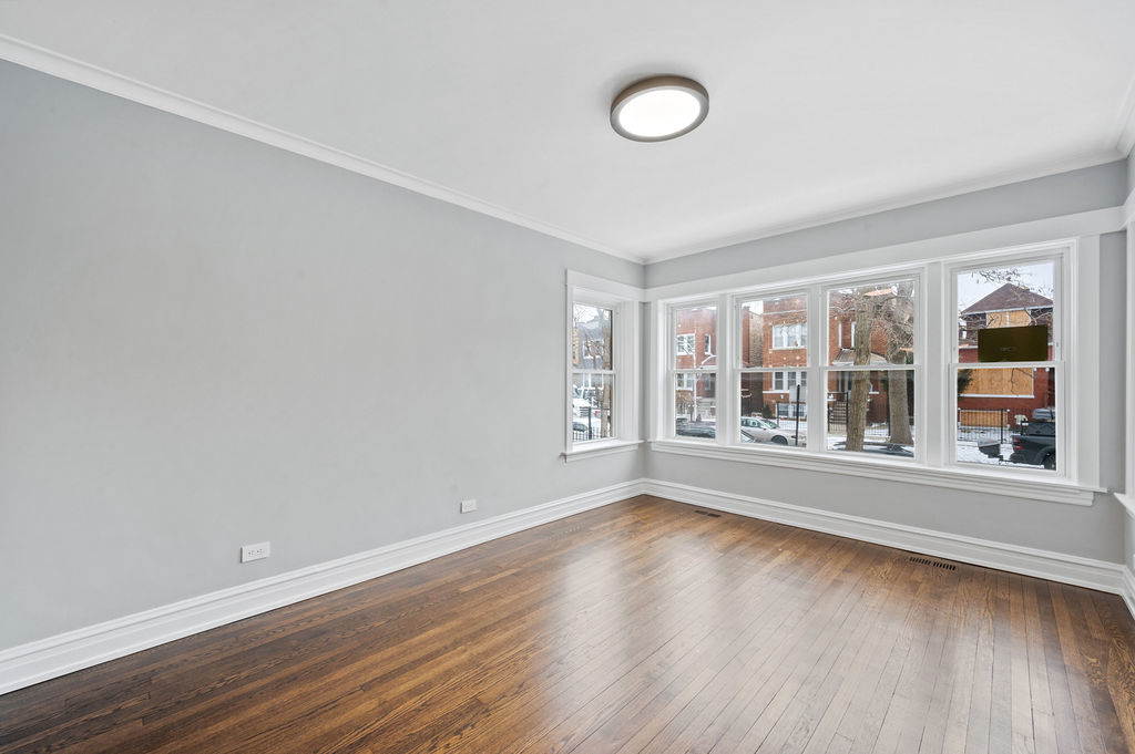 5230 West Deming Place Chicago, IL 60639 - Photo 38 of 45 a view of empty room with wooden floor and fan