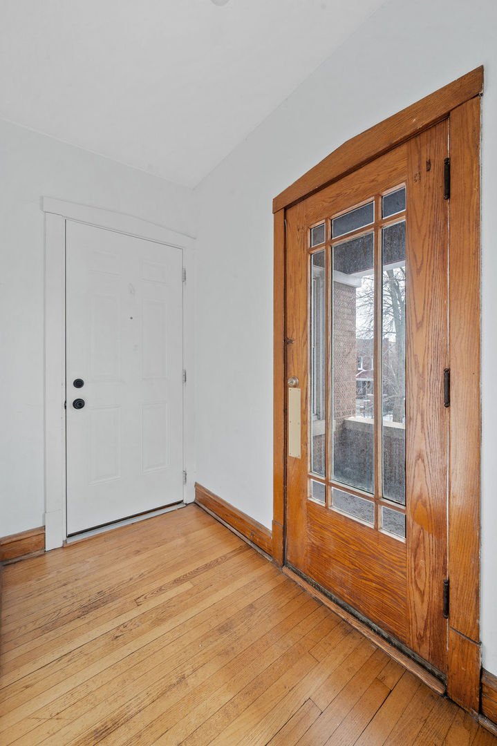 5230 West Deming Place Chicago, IL 60639 - Photo 40 of 45 an empty room with wooden floor and windows
