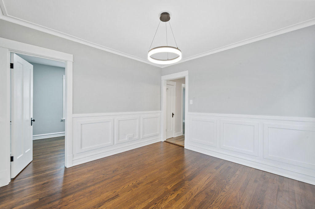 5230 West Deming Place Chicago, IL 60639 - Photo 10 of 45 an empty room with wooden floor and windows