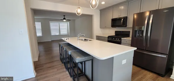 a kitchen with kitchen island a sink appliances and cabinets