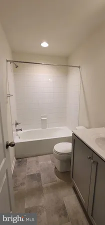 a bathroom with a toilet a sink and bathtub