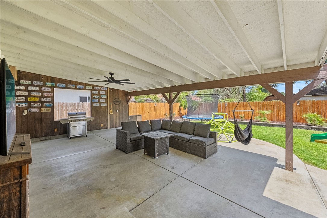 4869 Serrano Place Riverside, CA 92504 - Photo 32 of 40 Large covered patio with comfortable seating, outdoor TV area, and space designed for year-round entertaining.