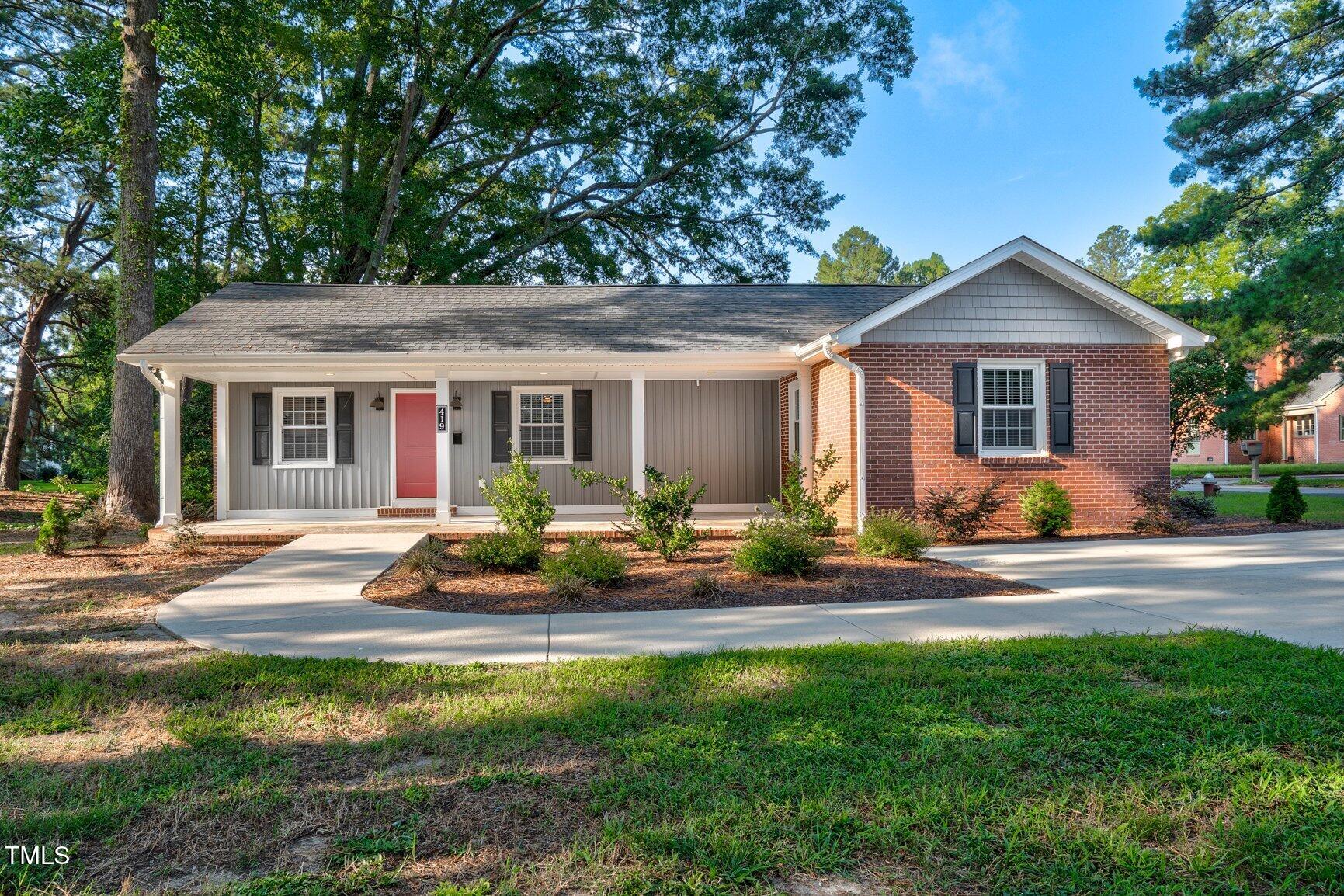 419 West Burnette Avenue Enfield, NC 27823 - Photo 1 of 23 a front view of house with yard and green space