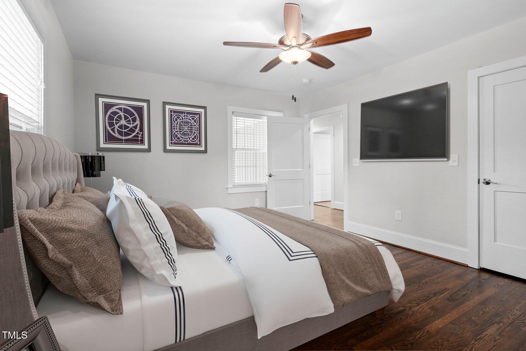 419 West Burnette Avenue Enfield, NC 27823 - Photo 11 of 23 a bedroom with a large bed and a flat screen tv