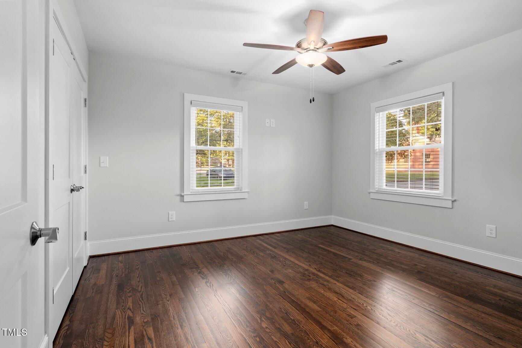 419 West Burnette Avenue Enfield, NC 27823 - Photo 17 of 23 wooden floor in an empty room with a window