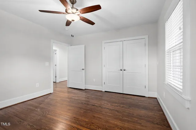 a view of a hallway with wooden floor and entryway