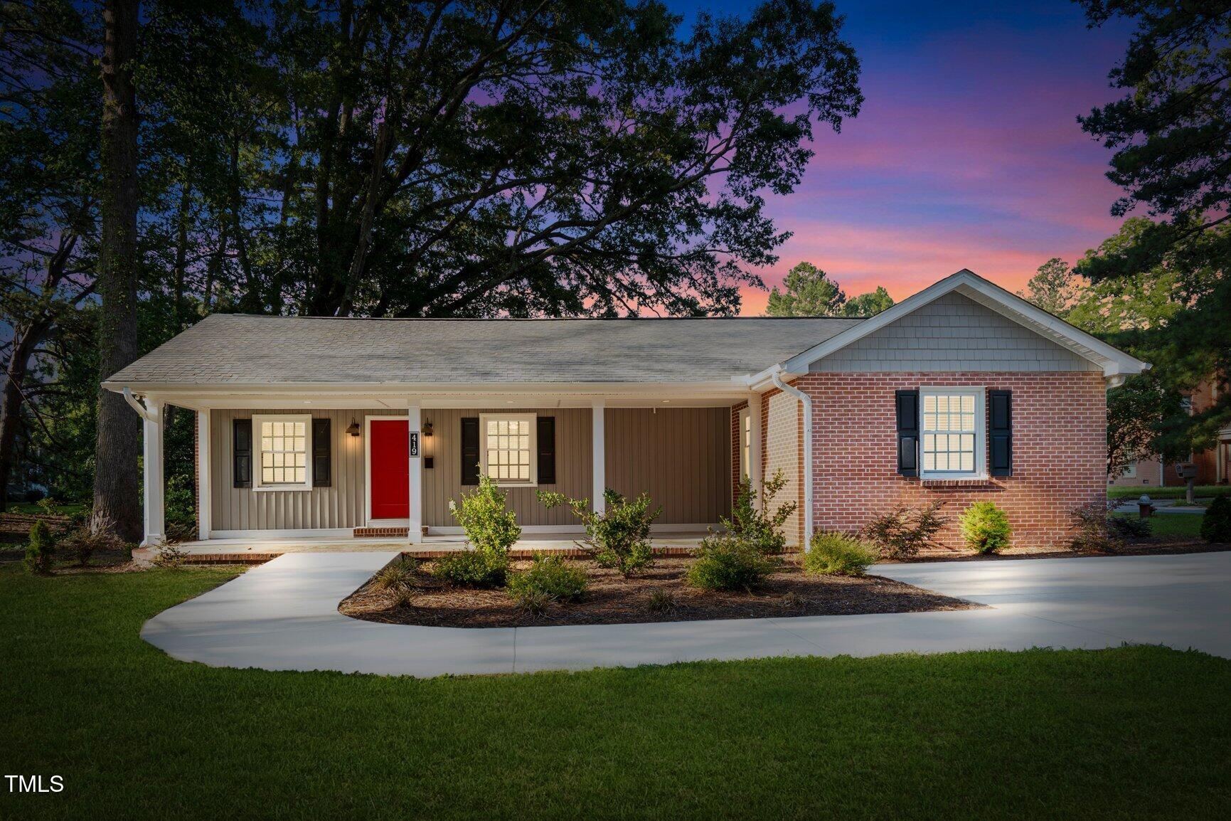 419 West Burnette Avenue Enfield, NC 27823 - Photo 2 of 23 a front view of house with yard outdoor seating and green space