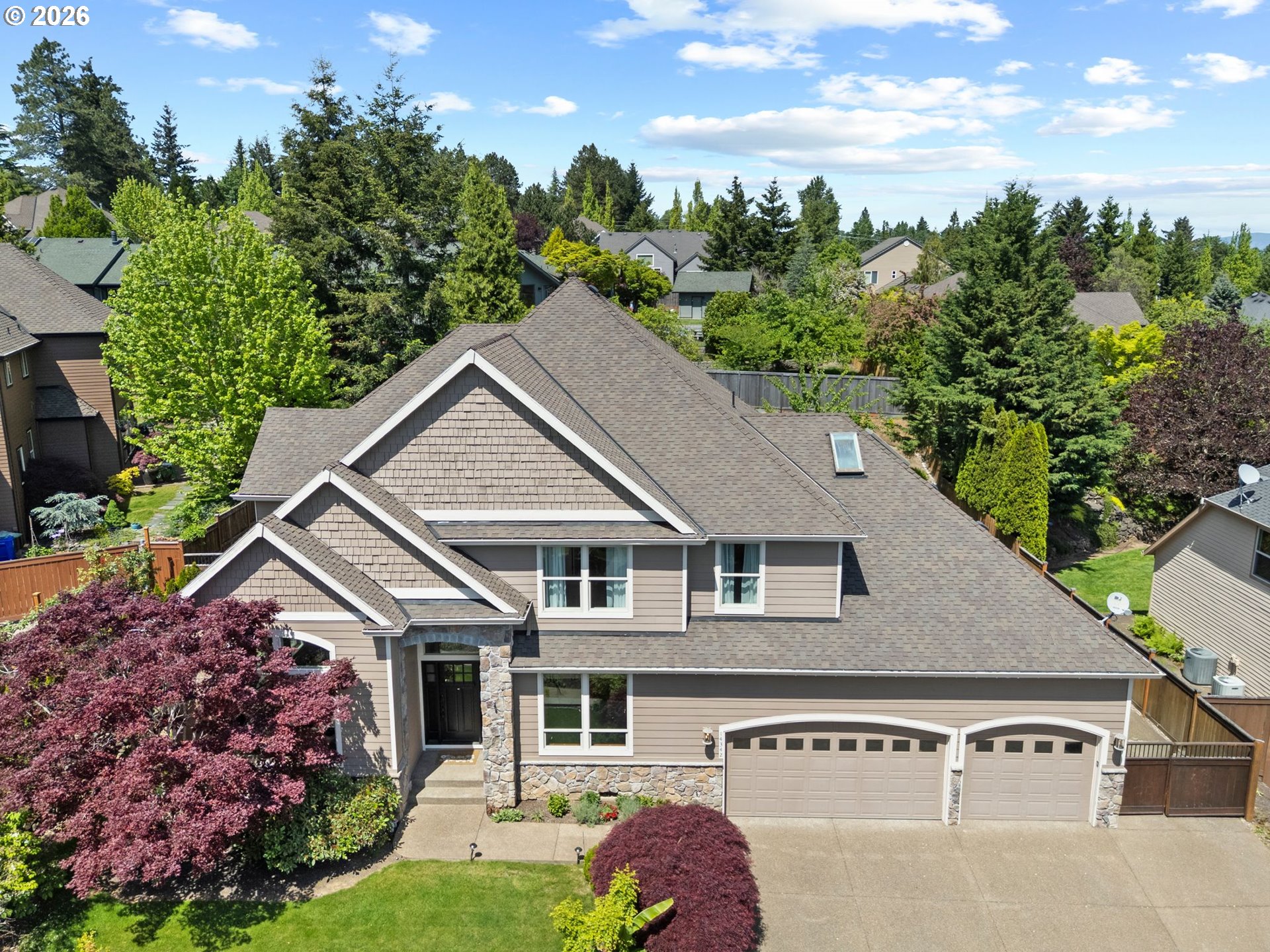 a aerial view of a house with a yard and potted plants