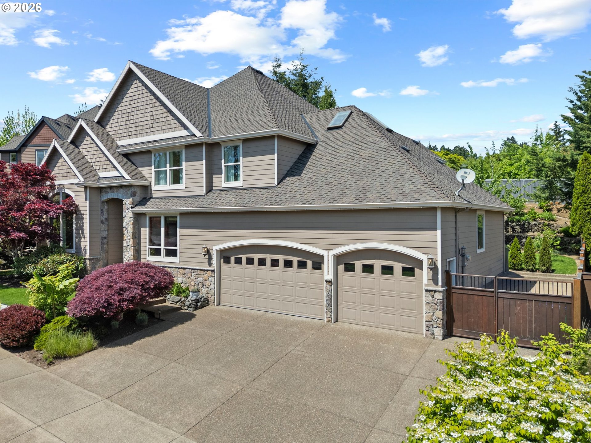 14342 Southeast Donatello Loop Happy Valley, OR 97086 - Photo 2 of 46 a front view of a house with garden