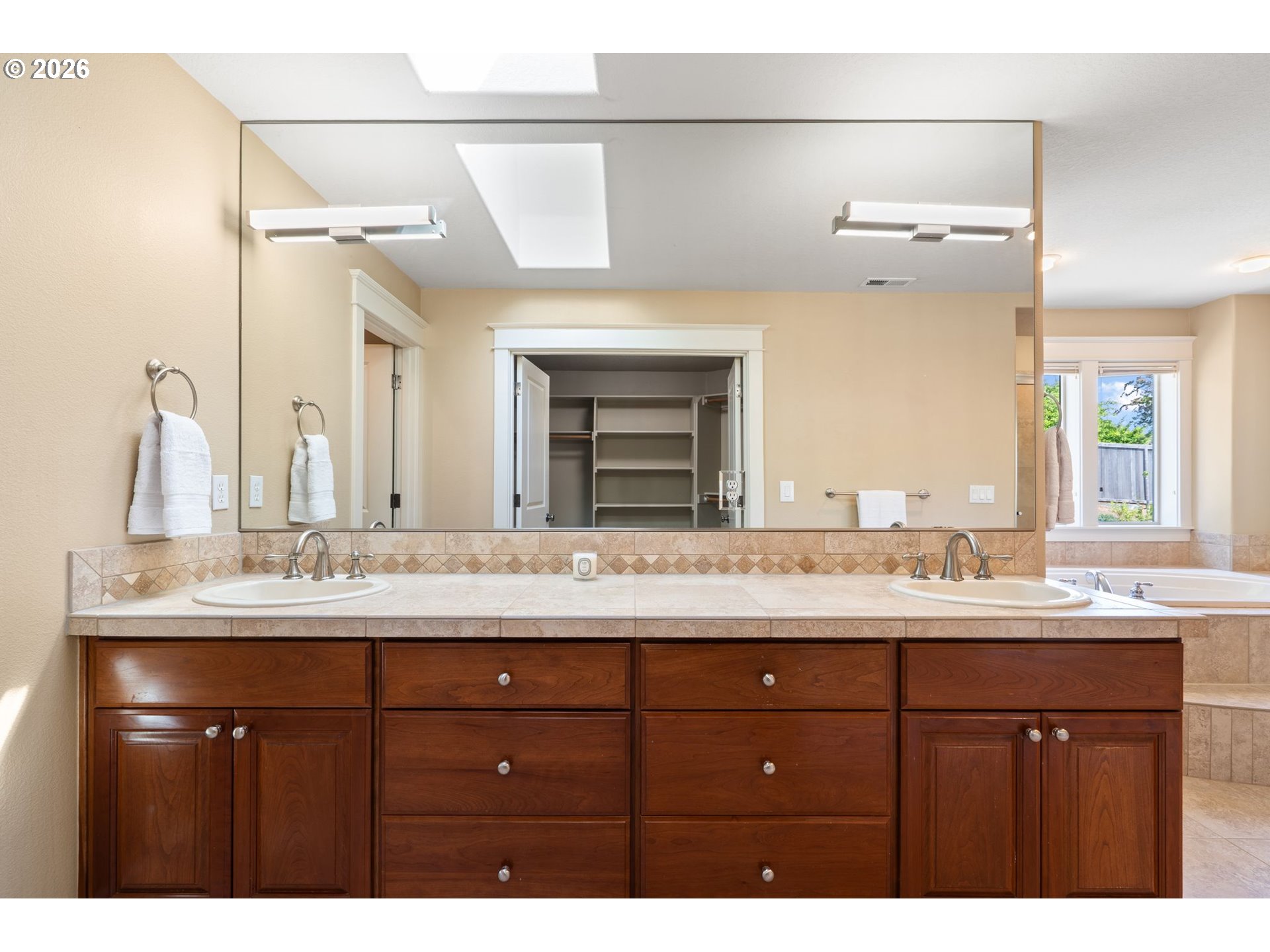 14342 Southeast Donatello Loop Happy Valley, OR 97086 - Photo 28 of 46 a bathroom with a granite countertop sink double vanity and a mirror