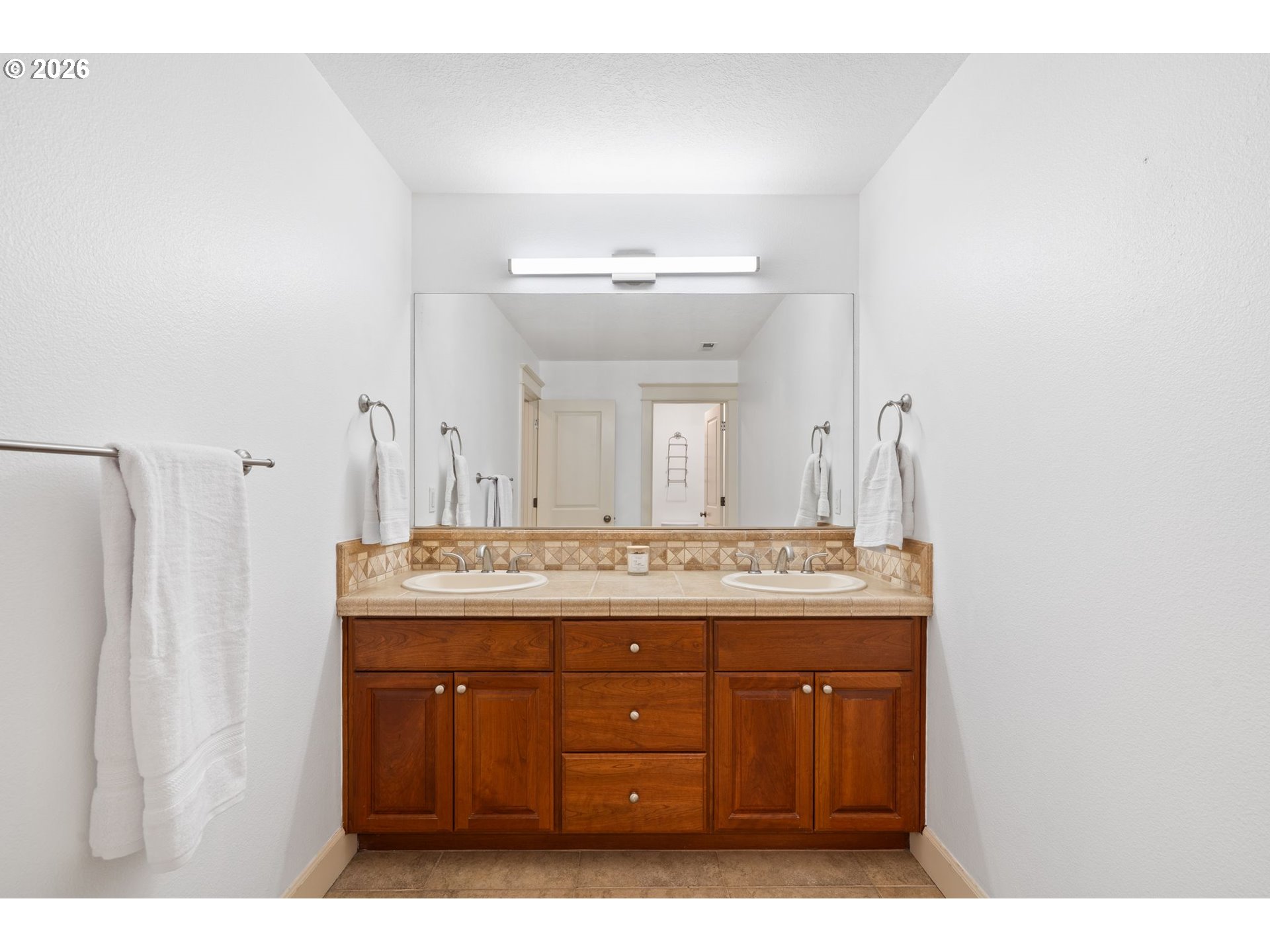 14342 Southeast Donatello Loop Happy Valley, OR 97086 - Photo 32 of 46 a bathroom with a granite countertop sink a mirror and a