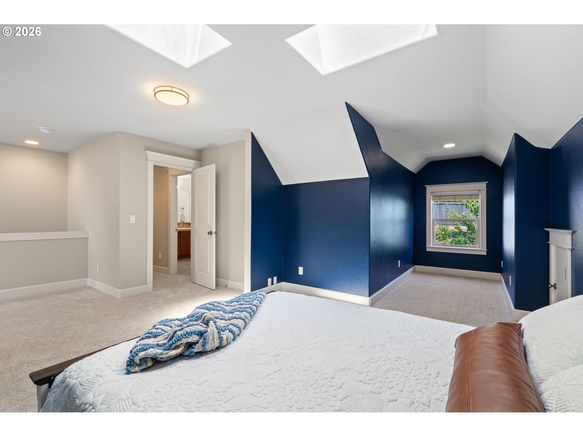 14342 Southeast Donatello Loop Happy Valley, OR 97086 - Photo 33 of 46 a bedroom with a bed and a lamp