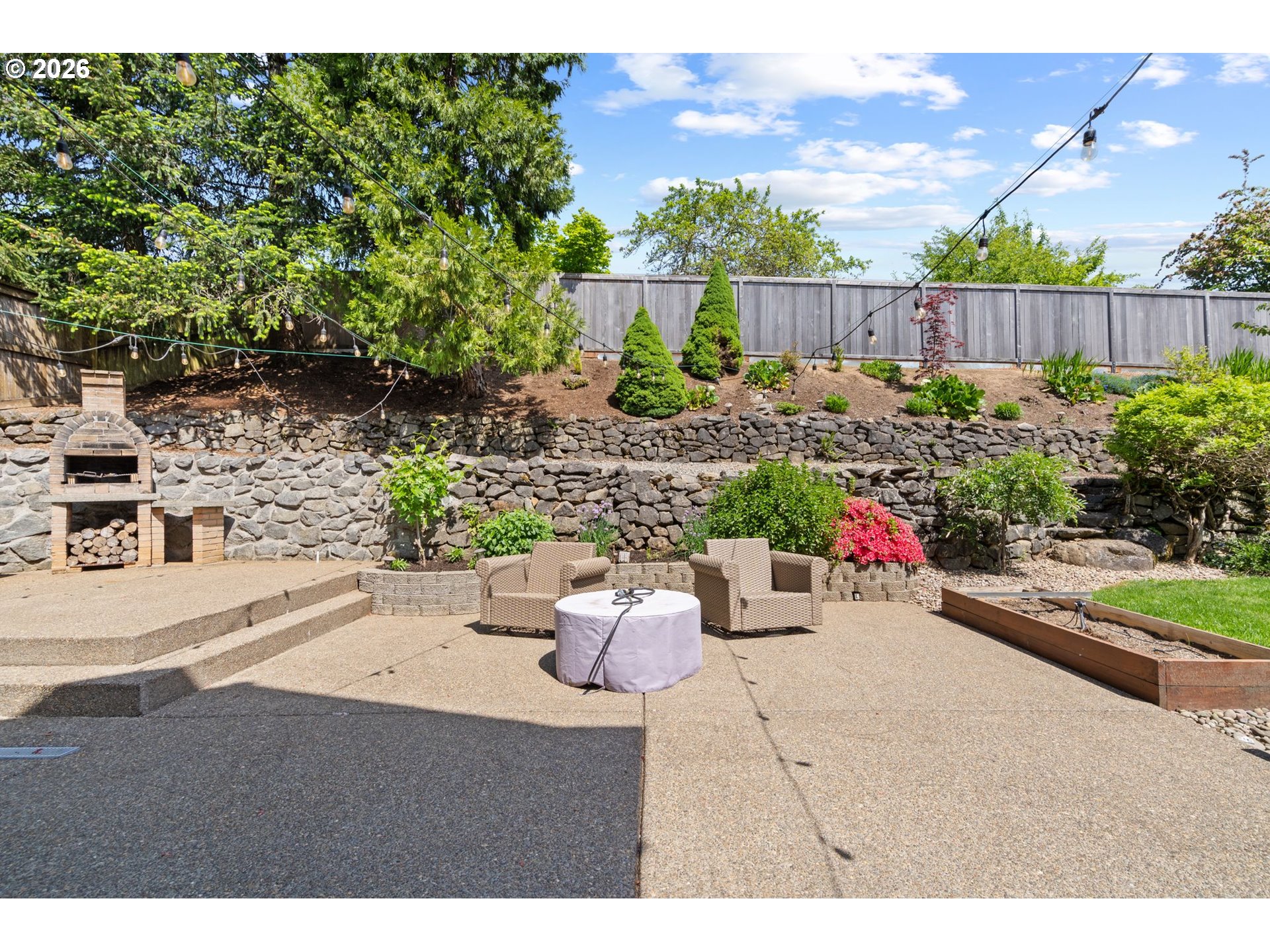 14342 Southeast Donatello Loop Happy Valley, OR 97086 - Photo 36 of 46 a view of a backyard with potted plants and a fountain