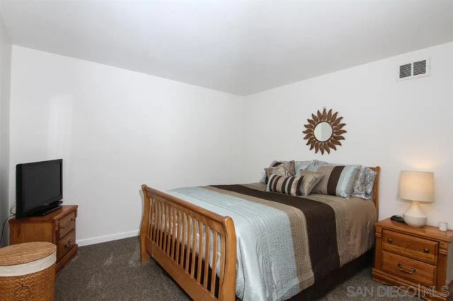 a bedroom with bed and a tv