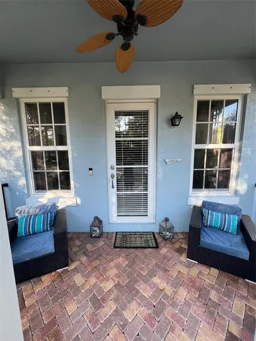 a view of a house with a lounge chair and a glass door