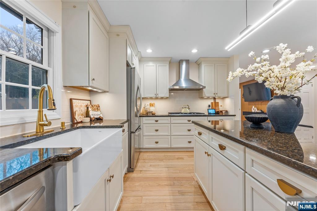 163 La Rue Road West Milford, NJ 07435 - Photo 15 of 28 a kitchen with kitchen island granite countertop a sink counter top space appliances and cabinets