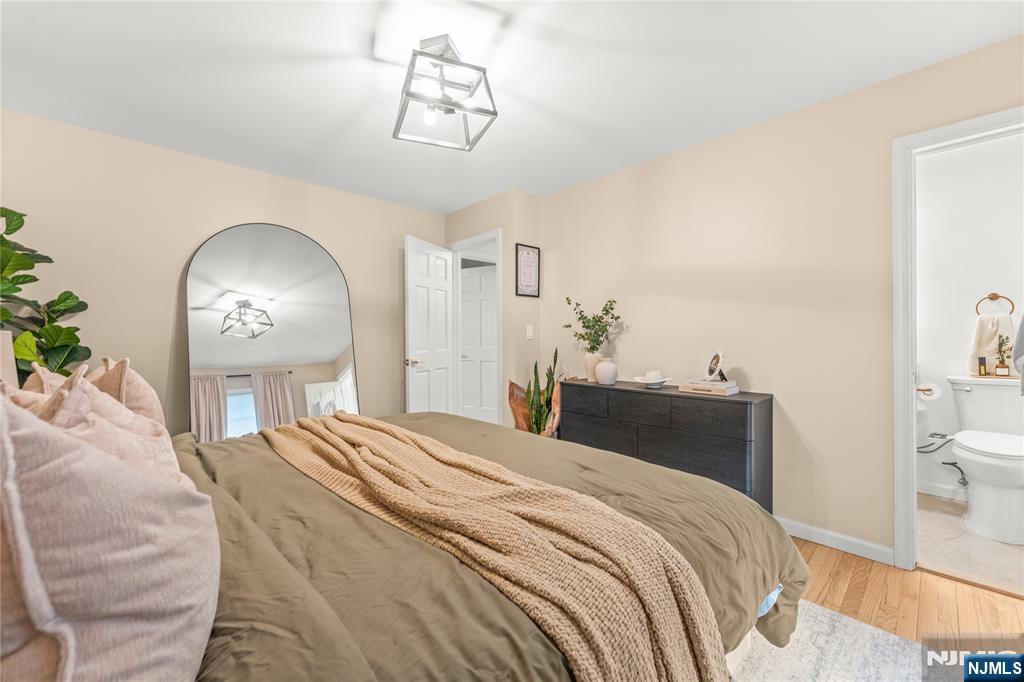 163 La Rue Road West Milford, NJ 07435 - Photo 20 of 28 a bedroom with a bed and a chandelier