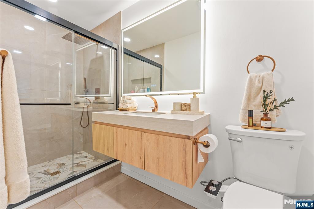 163 La Rue Road West Milford, NJ 07435 - Photo 21 of 28 a bathroom with a sink a mirror and a shower