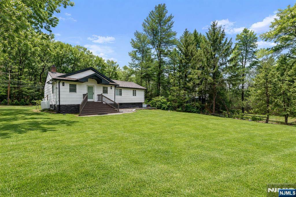 163 La Rue Road West Milford, NJ 07435 - Photo 26 of 28 a front view of a house with a garden