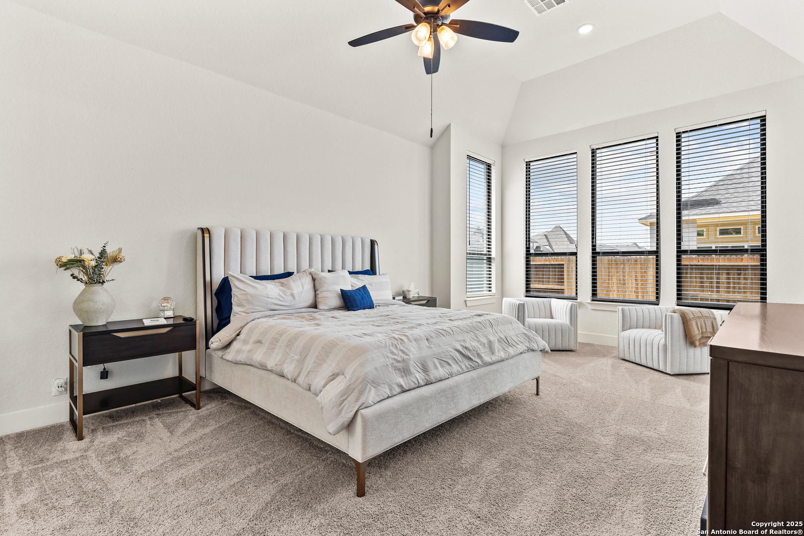 507 Caliban Cibolo, TX 78108 - Photo 23 of 63 a spacious bedroom with a bed and a chandelier