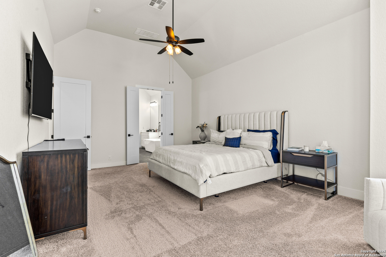507 Caliban Cibolo, TX 78108 - Photo 26 of 63 a bedroom with a bed and a flat tv screen on wall