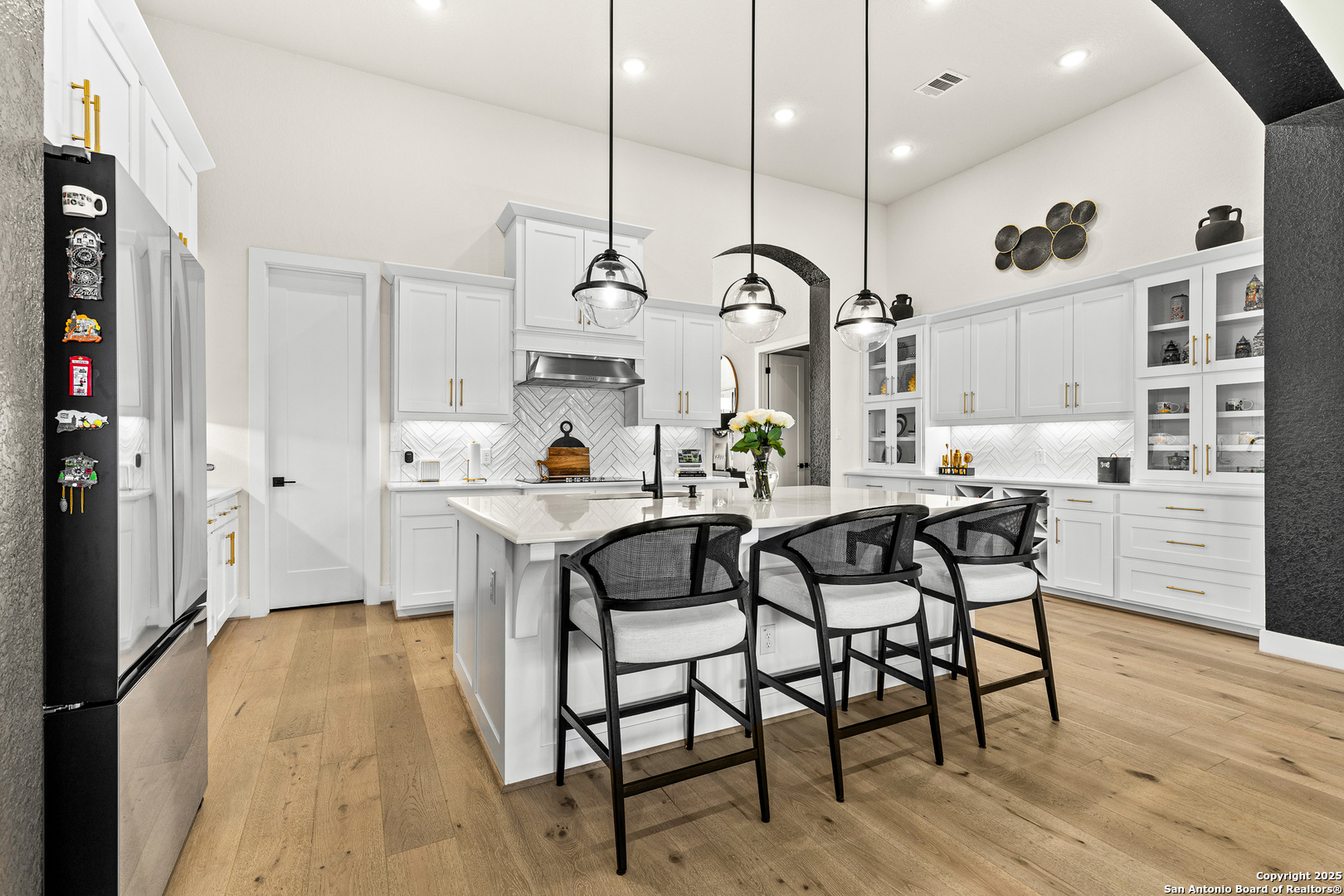 507 Caliban Cibolo, TX 78108 - Photo 8 of 63 a kitchen with stainless steel appliances granite countertop a table chairs stove and wooden floor