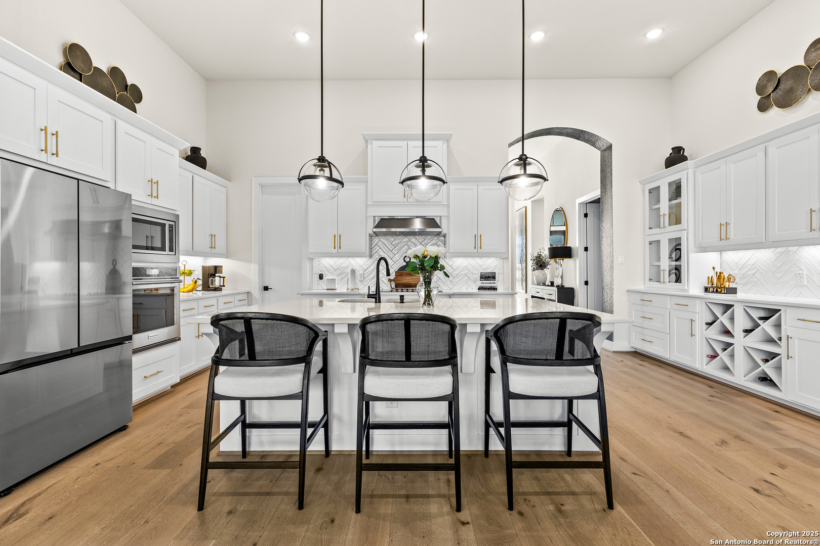 507 Caliban Cibolo, TX 78108 - Photo 10 of 63 a kitchen with stainless steel appliances kitchen island granite countertop a table and chairs in it