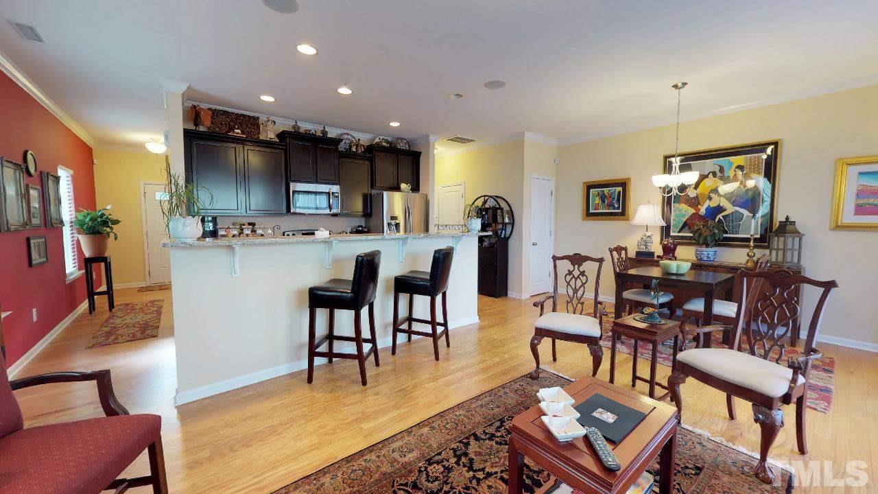 1023 Ileagnes Road Raleigh, NC 27603 - Photo 12 of 25 a living room with stainless steel appliances furniture a dining table and kitchen view