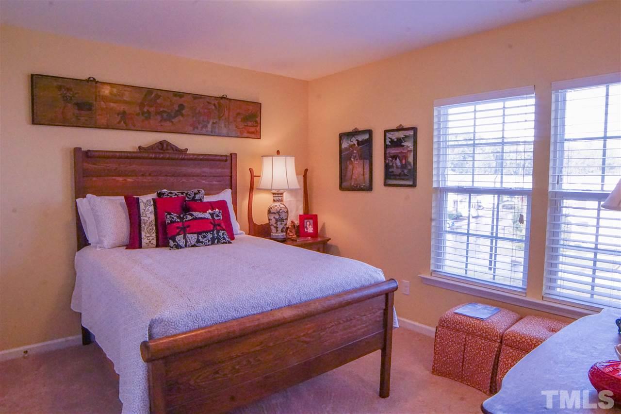 1023 Ileagnes Road Raleigh, NC 27603 - Photo 18 of 25 a bedroom with a bed and wooden floor