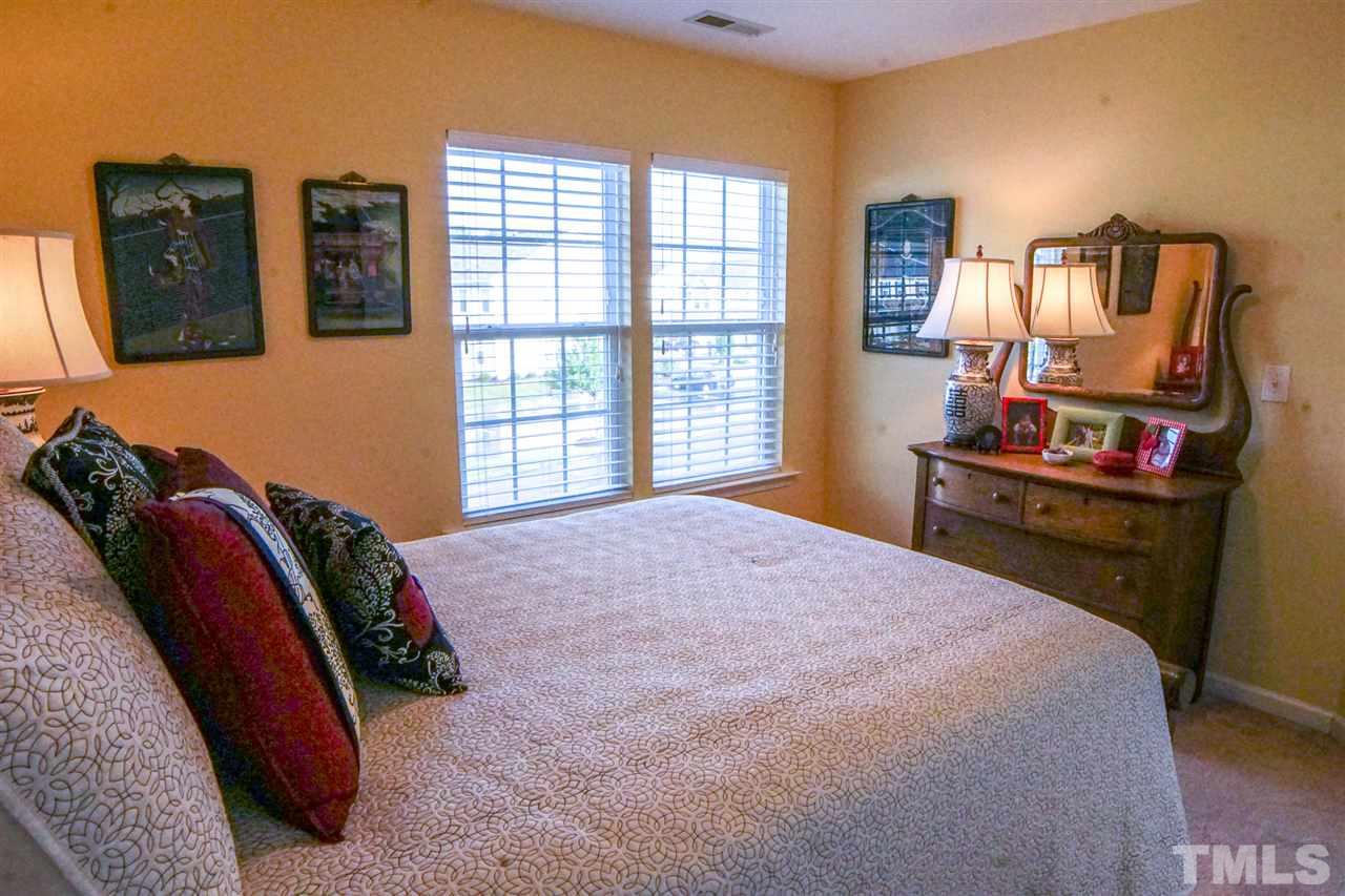 1023 Ileagnes Road Raleigh, NC 27603 - Photo 19 of 25 a bedroom with a bed and wooden floor
