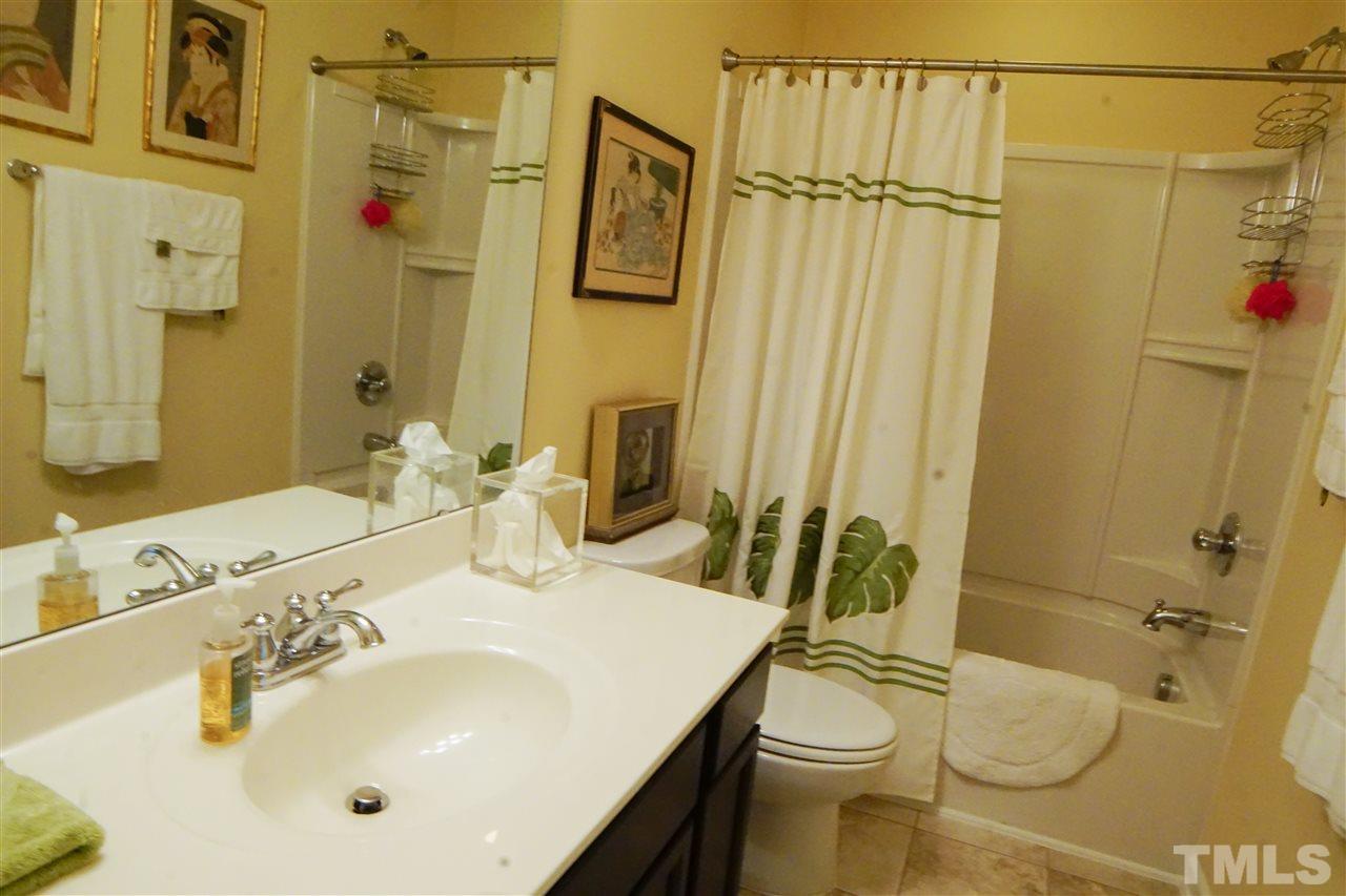 1023 Ileagnes Road Raleigh, NC 27603 - Photo 21 of 25 a bathroom with a sink a toilet and shower